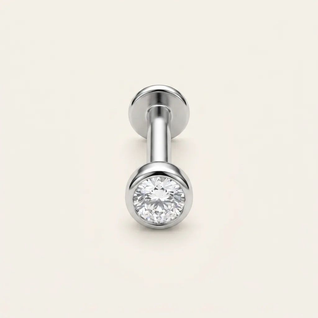 Titanium Ashley piercing solitaire studs in silver and gold finishes side by side
