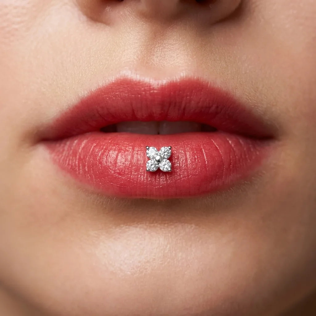 Silver titanium Ashley clover piercing worn in the center of the lower lip
