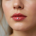 Silver titanium Ashley heart piercing worn in the center of the lower lip
