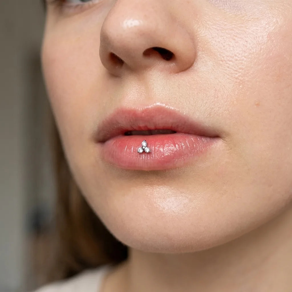 Silver titanium Ashley trinity piercing worn in the center of the lower lip

