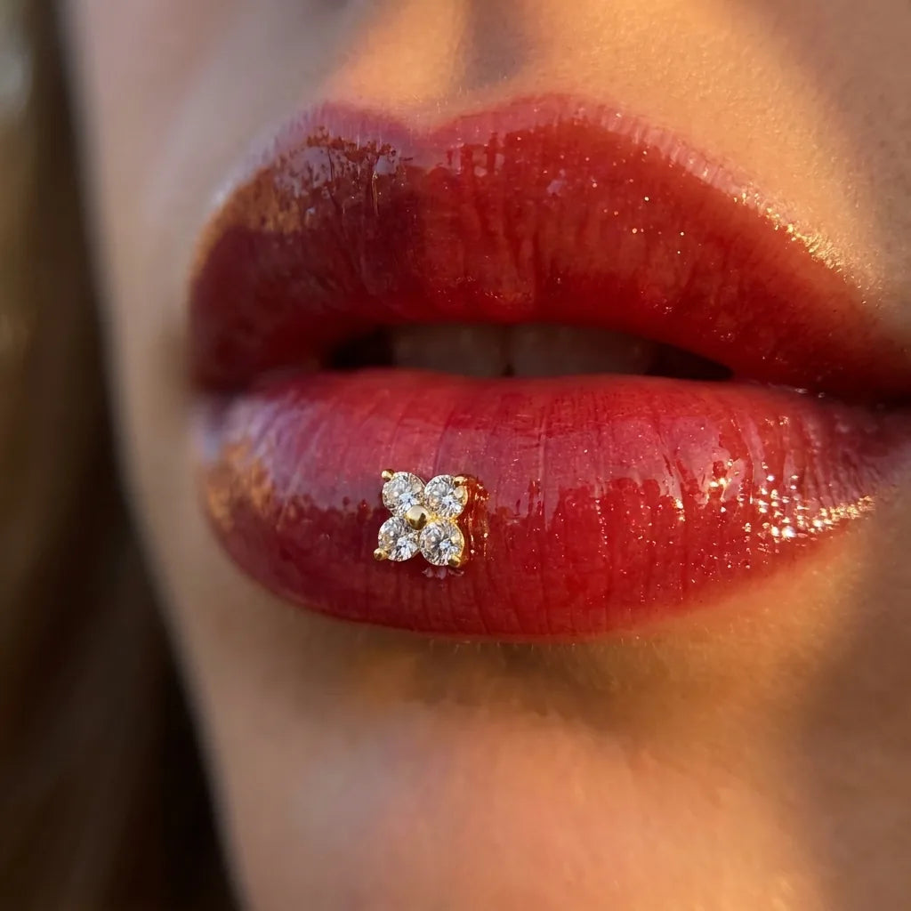 Gold titanium Ashley clover piercing worn in the center of the lower lip
