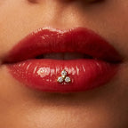 Gold titanium Ashley trinity piercing worn in the center of the lower lip
