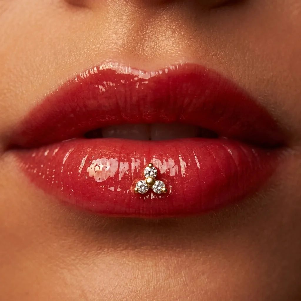 Gold titanium Ashley trinity piercing worn in the center of the lower lip

