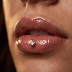 Gold titanium Ashley piercing solitaire with a bezel set CZ, three quarter angle

