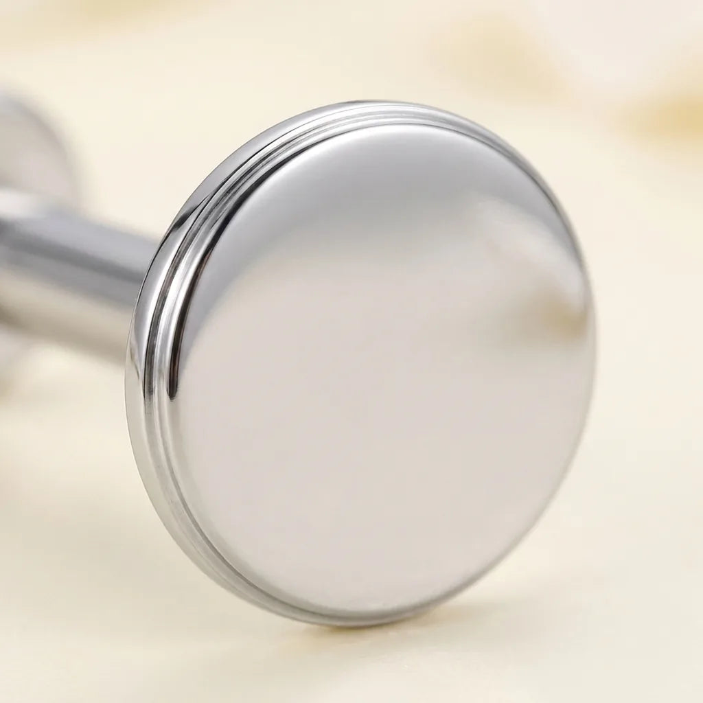 Macro close up of a mirror polished titanium Ashley flat disc stud
