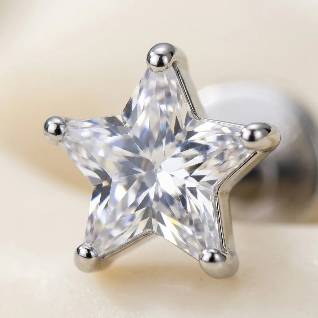 Macro close up of a star cut cubic zirconia held in titanium prongs
