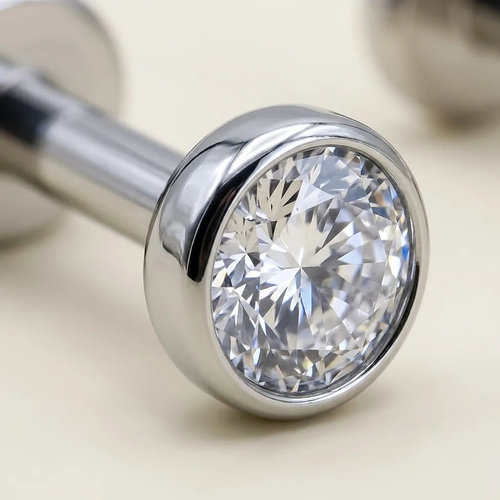Macro close up of a mirror polished titanium Ashley piercing bezel set CZ solitaire
