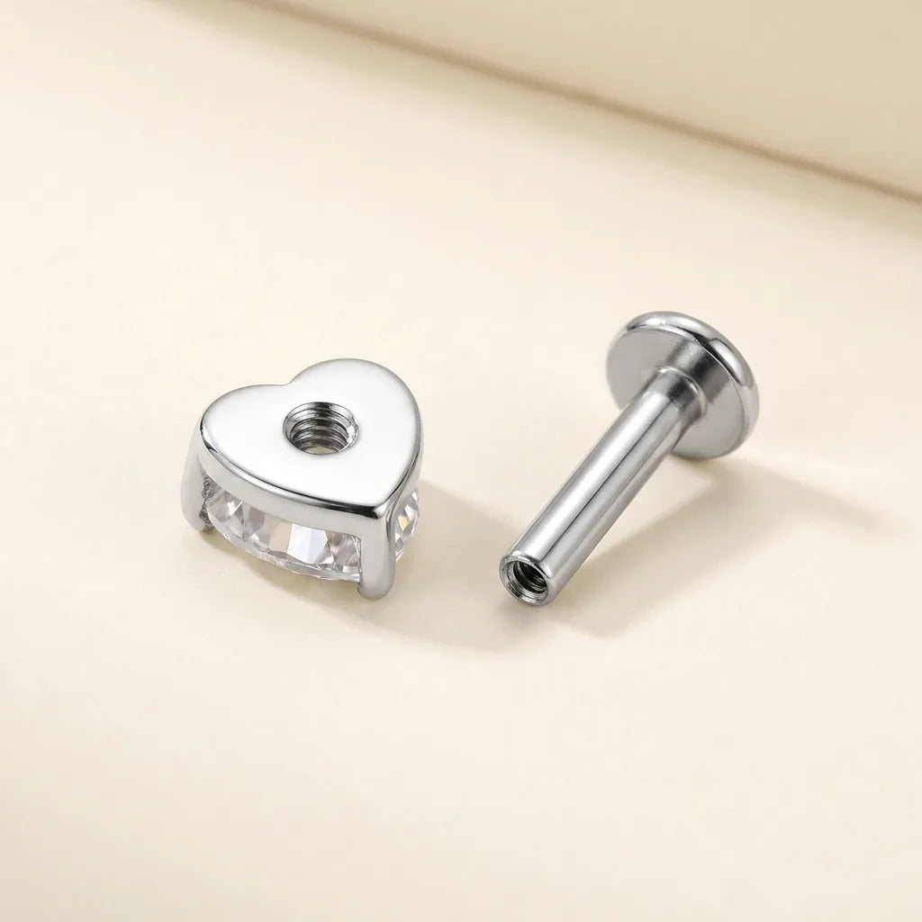 Internally threaded titanium Ashley heart labret with the top and post separated
