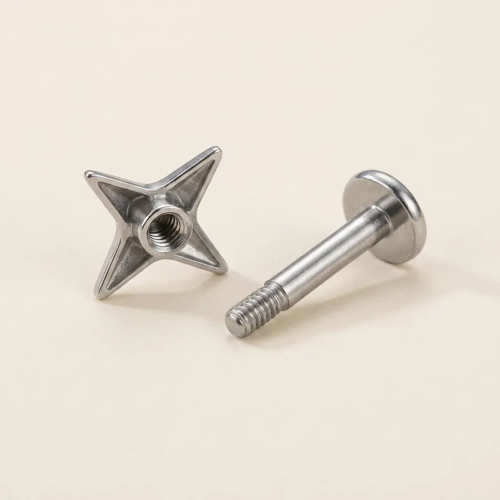 Internally threaded titanium Ashley star labret with the top and post separated
