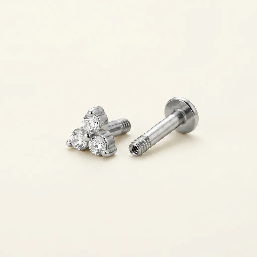 Internally threaded titanium Ashley trinity labret with the top and post separated
