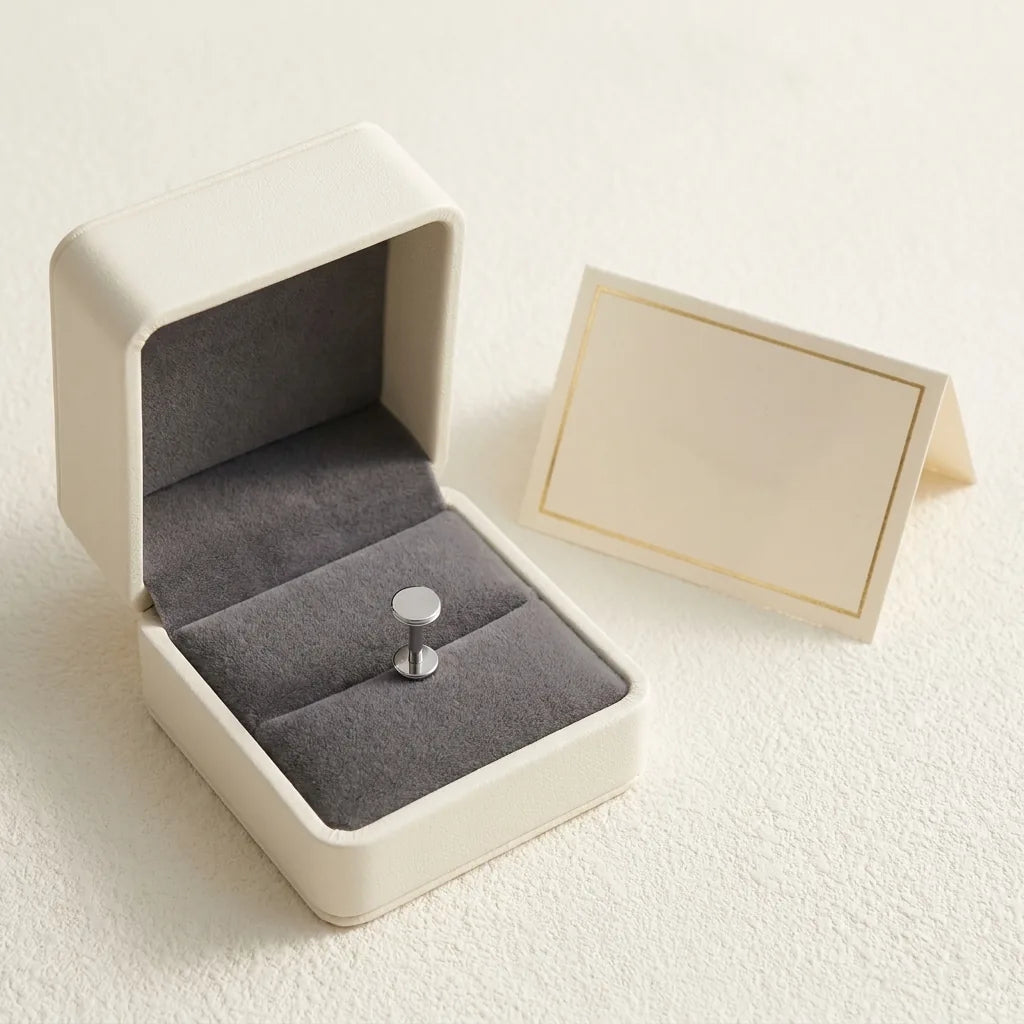 Ashley disc piercing gift packaging with a titanium stud and a certificate card
