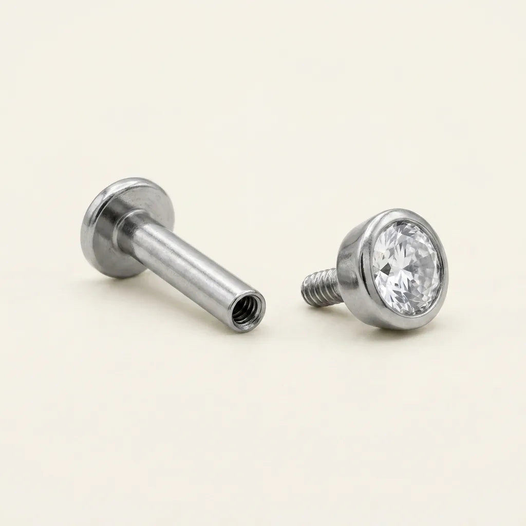 Internally threaded titanium Ashley piercing labret with the top and post separated
