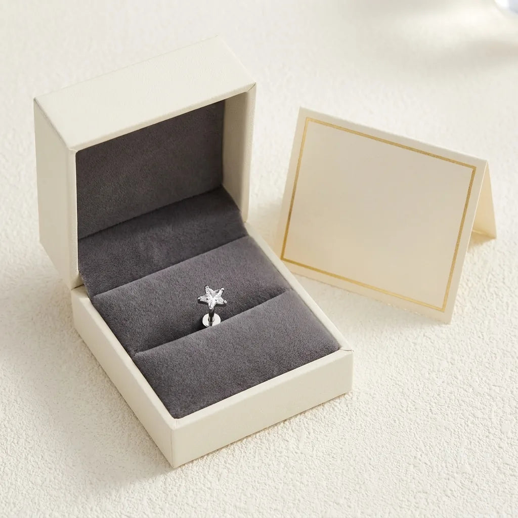 Ashley star cut piercing gift packaging with a titanium stud and a certificate card
